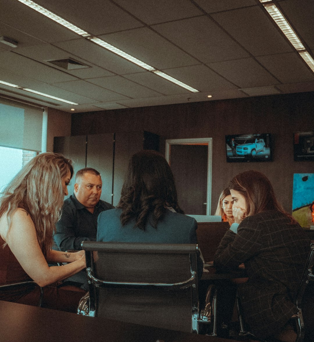 Two Brazilian colleagues having a friendly conversation in a bright office