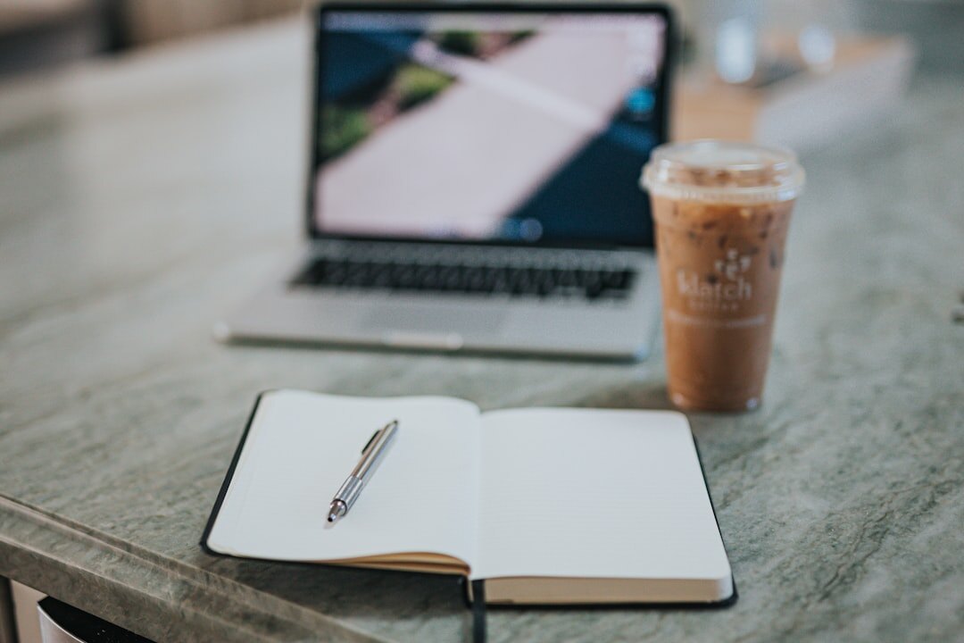Two cups of coffee and a notebook set up for a conversation