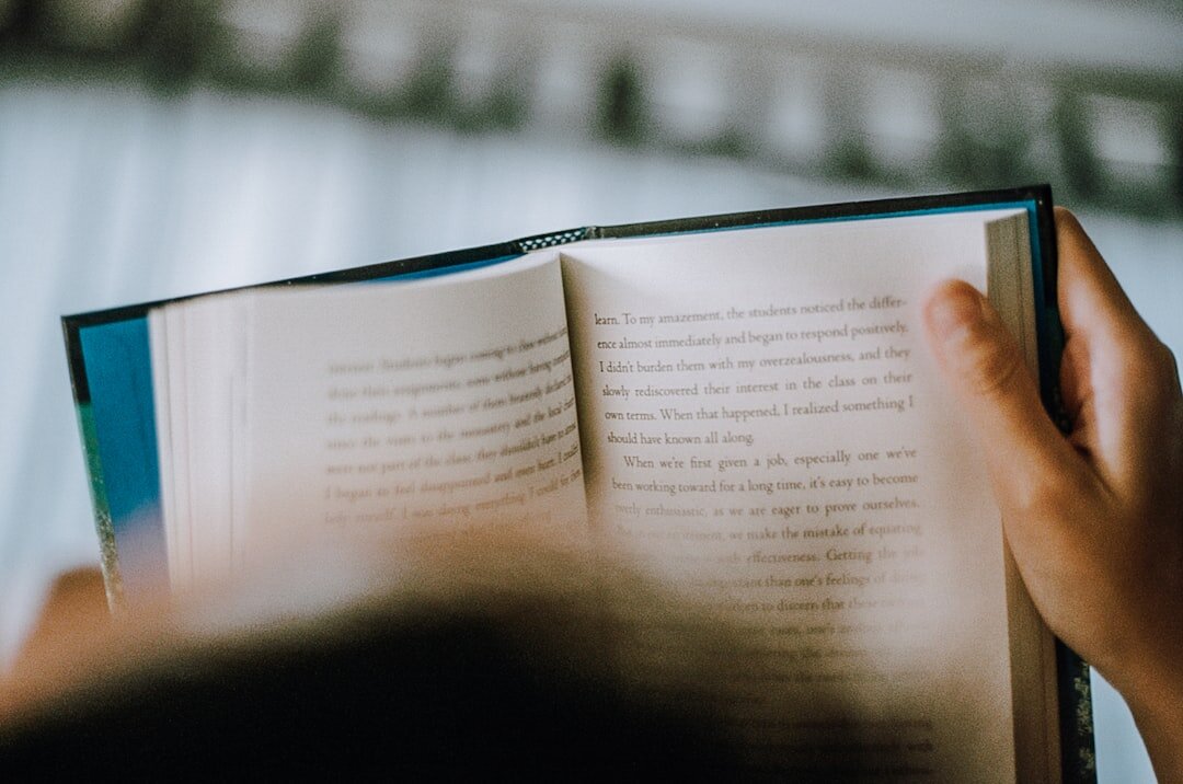 person reading book at home