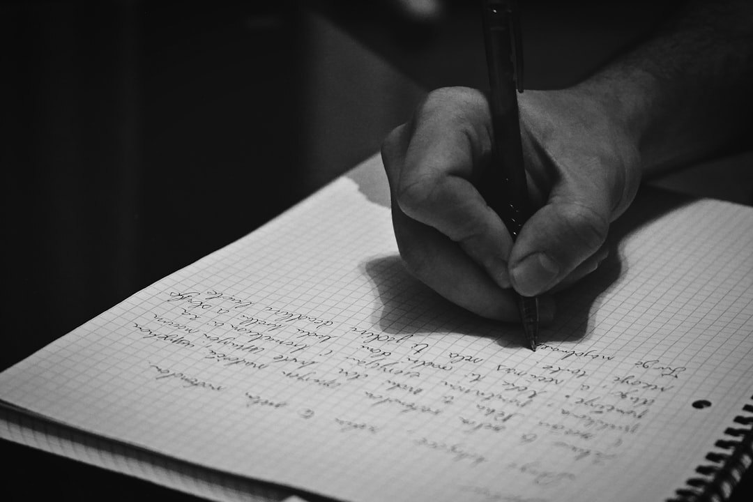 person writing in journal