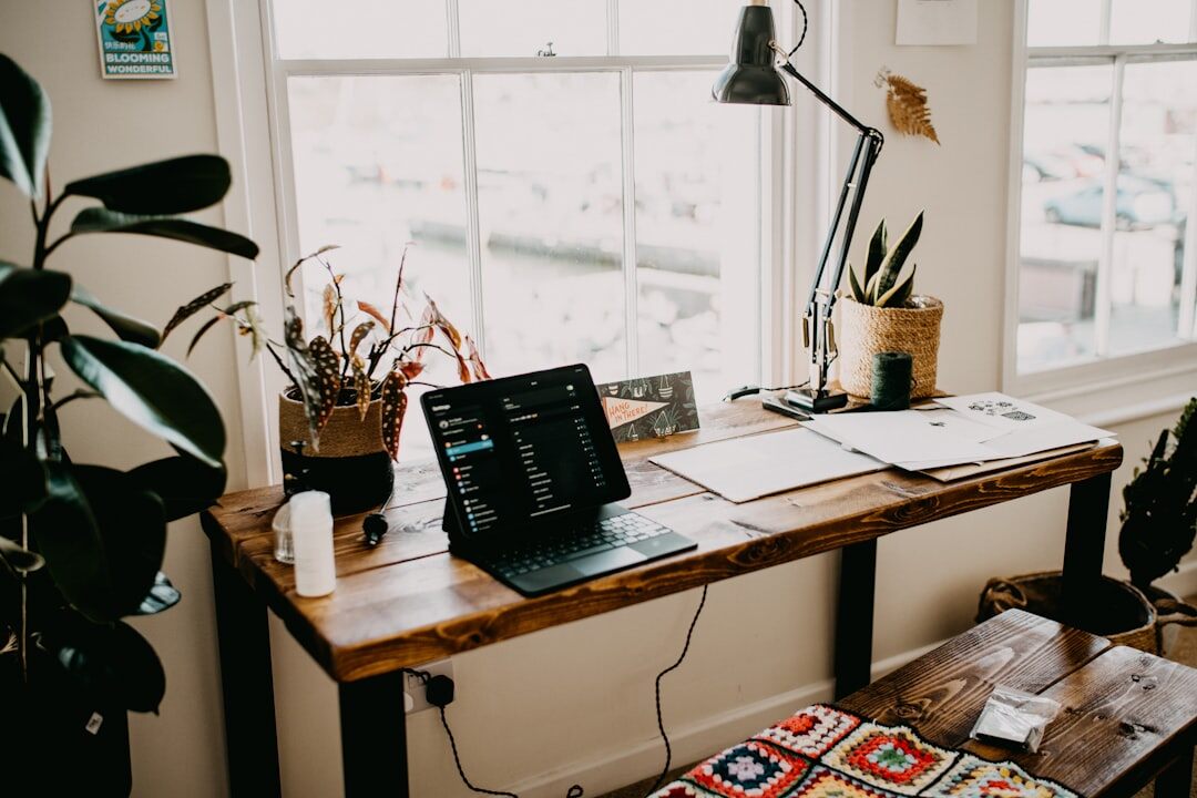 Bright minimal office workspace with plants and a wooden desk